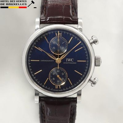 a close up of a wrist watch with a blue dial