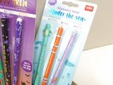 five different pens in the package on the table