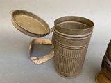 a small metal container with a lid and a small metal container with a lid