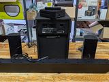 two speakers sitting on top of a wooden table