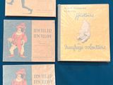 four books are sitting on a blue surface with a blue background
