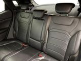 the back seats of a car are black with red trims