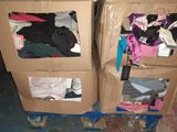 two boxes that have clothes in them on the floor