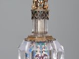 a glass bottle with a skull on it on a table