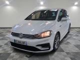 the white volkswagen golf is parked on a checkered floor