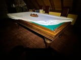 a pool table with a white cloth on top of it
