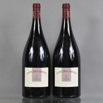 two bottles of red wine sitting on top of a table