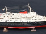 a model of a ship on a stand on a black background
