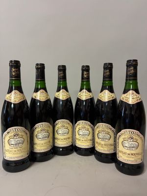 six bottles of wine lined up in a row on a table