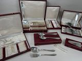 a lot of silverware in a case on a table