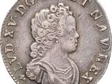 a silver coin with an image of a woman in profile