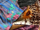 many different types of scarves and scarves laid out on a table