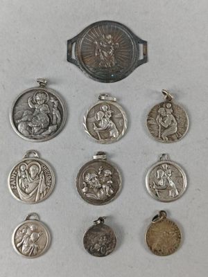 six silver medals and a silver medal on a white surface