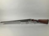 a rifle with a wooden barrel and a metal handle
