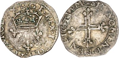 a silver coin with a crown and cross on it
