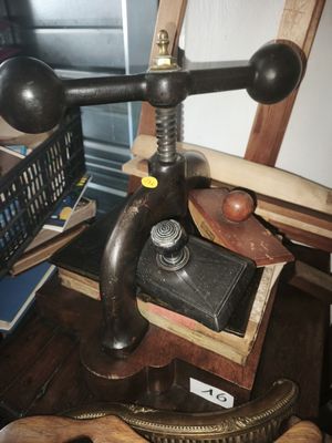 a wooden table topped with books and a metal object