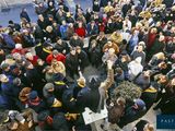 a large crowd of people standing outside of a building