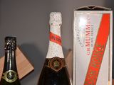 a bottle of champagne and a box of wine on a table