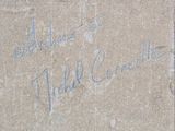 a sign on the side of a building that has graffiti written on it