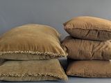 several pillows are stacked on top of each other on a table