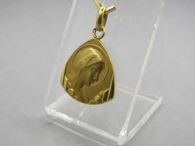 a close up of a gold medal in a clear display case
