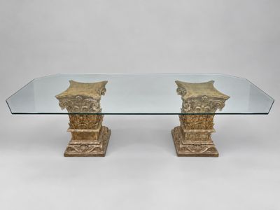 a glass table with two columns and a glass top