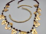 a close up of a necklace and bracelet on a table