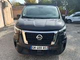 the front view of a black nissan terravan parked in a parking lot