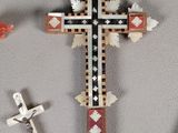three crosses on the wall next to a pair of scissors