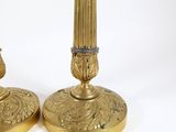 pair of antique brass candlesticks with floral designs on the bases