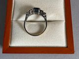 a diamond ring in a wooden box on a table