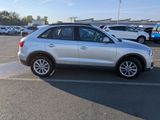 the white car is parked in the parking lot near other cars