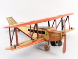 a toy airplane that is sitting on a white surface