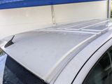 the roof of a car with a blue tarp on it