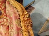 a close up of a chair with a rose on it
