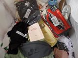 a pile of clothing and other items in a trash can