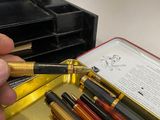 a person that is holding a pen in a case