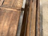 several pieces of wood sit on the ground next to a bicycle
