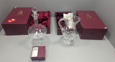 two glass vases and a wine glass on a table