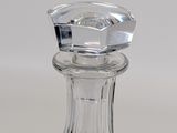 a clear glass bottle with a stopper on top of it