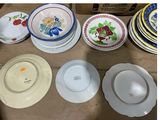 many plates and bowls sitting on a table