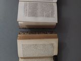three open books sitting on top of each other on a table