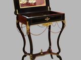 a small desk with a mirror on top of it