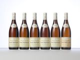 six bottles of wine are lined up on a table