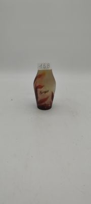 a small glass vase with a brown and white design on it