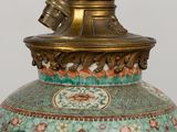 a large vase with a bird on top of it