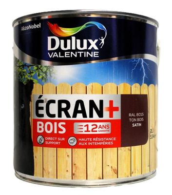 un pot de peinture avec une clôture en bois en arrière-plan