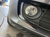 a close up of a car ' s headlight with a sticker on it