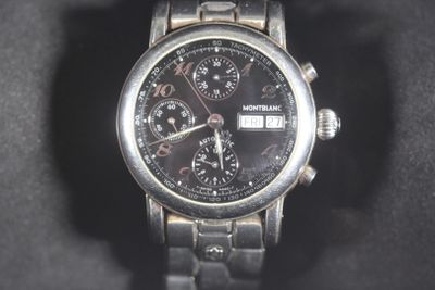 a close up of a watch on a black surface