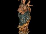 an image of a statue of the virgin mary holding a child